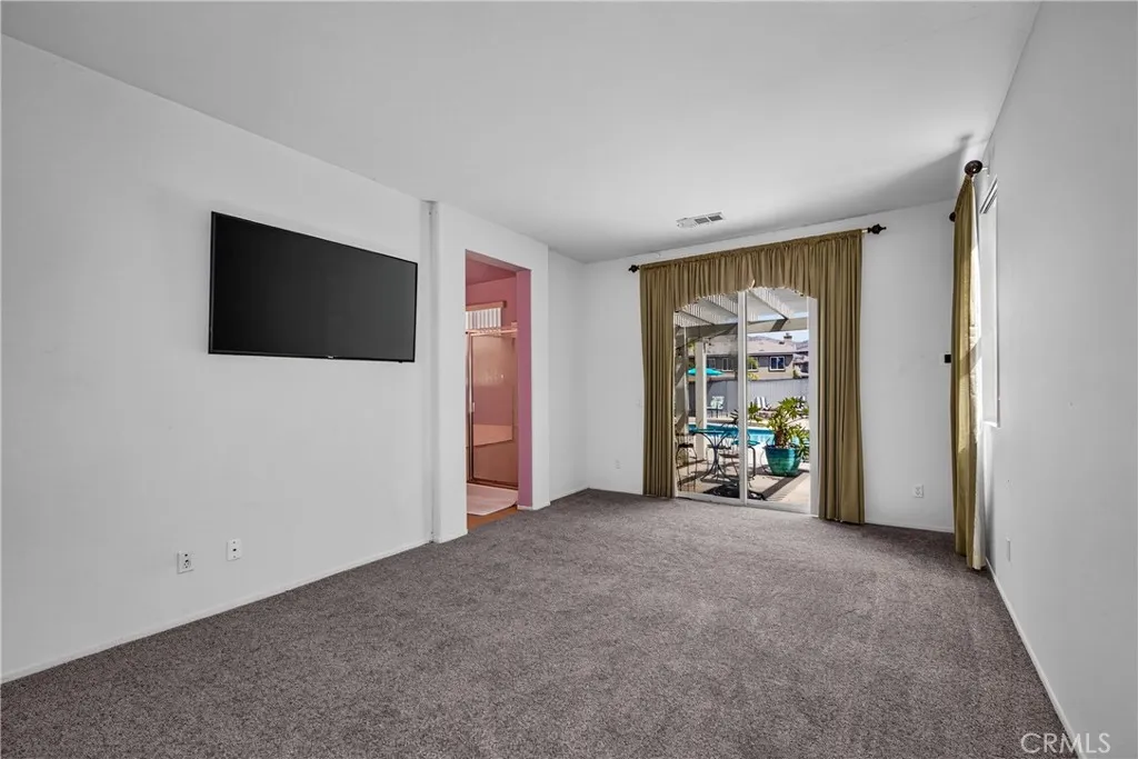 Primary Bedroom with slider to the backyard. Brand new carpet just installed!!