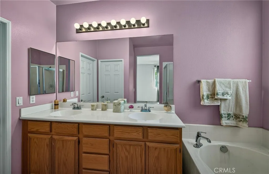 Primary Bathroom with double vanity, tub and separate shower.