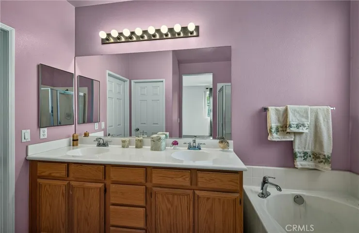 Primary Bathroom with double vanity, tub and separate shower.