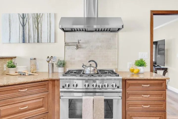 DCS 6-burner gas range & Hood. Pot filler. Plenty of cabinet space.