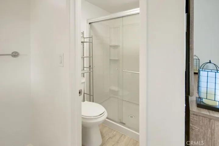 Updated primary bathroom includes a beautifully remodeled walk-in shower with sleek glass enclosure.