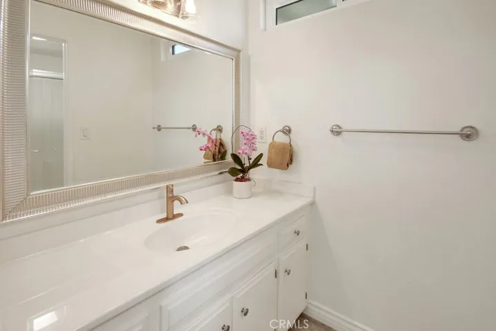 Remodeled primary bathroom showcases an oversized vanity, updated fixtures, and ample storage.