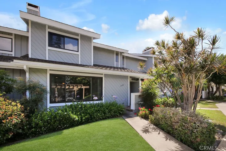 Attractive front exterior welcomes you with lush landscaping in a beautifully maintained community.