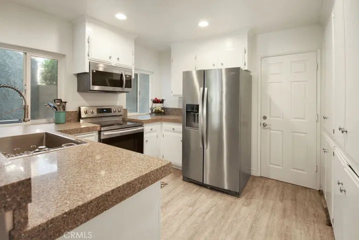 Well-designed kitchen offers ample cabinetry, newer appliances, and an efficient layout for everyday living.
