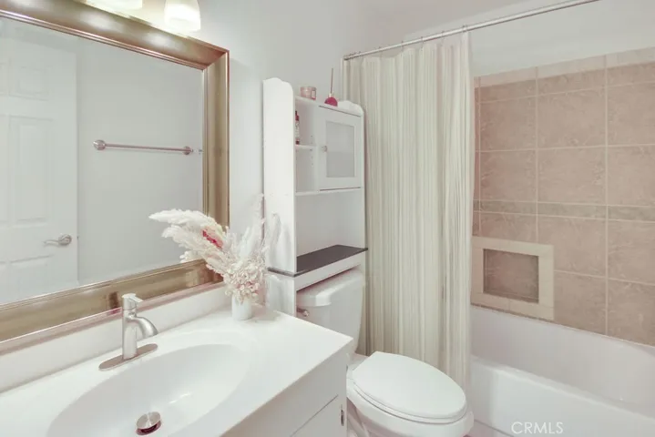 Secondary bathroom features an updated vanity, modern fixtures, and a tub/shower combination.
