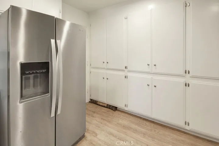 Updated kitchen features recently refinished cabinetry, stainless steel appliances, and abundant counter space.