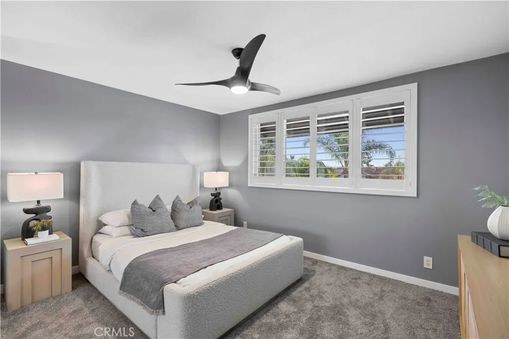 Quiet guest bedroom w/ classic shutters & ceiling fan for fresh breezes