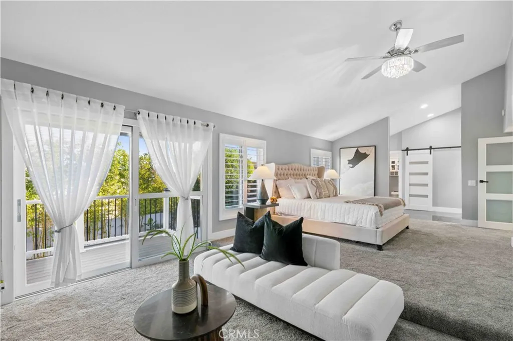 Direct access to a private balcony overlooking the beautifully landscaped backyard and surrounding neighborhood