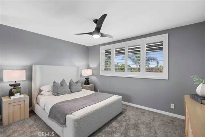 Quiet guest bedroom w/ classic shutters & ceiling fan for fresh breezes