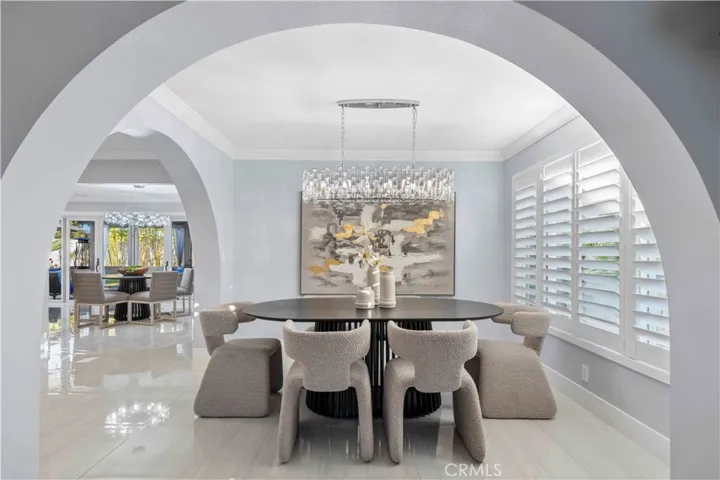 A stylish front entry welcomes you into a light-filled interior featuring soaring ceilings, an elegant living room, and a formal dining area ideal for entertaining