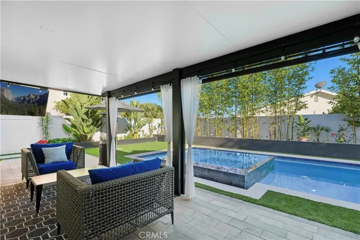 Exceptional indoor-outdoor living enhanced by the 22-foot bifold patio door system and resort-style backyard