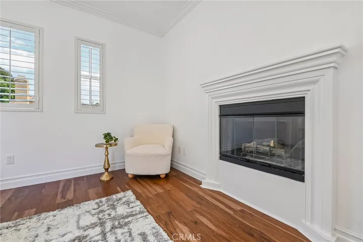 sitting area by fireplace in primary bedroom