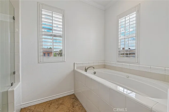 separate bathtub and shower in primary bathroom