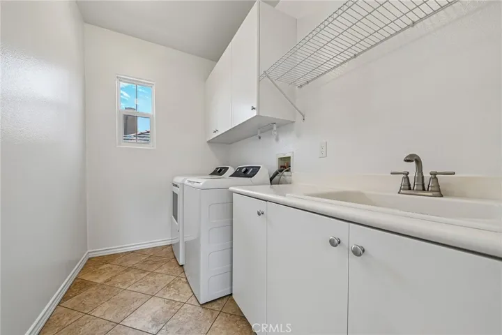 upstairs laundry room with sink