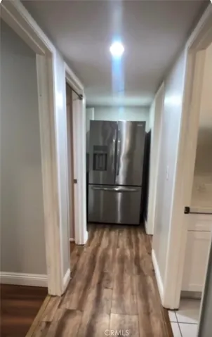 Hallway on left is fridge & cabinetry