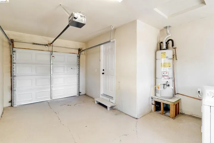 Two-car garage with overhead door opener and concrete flooring