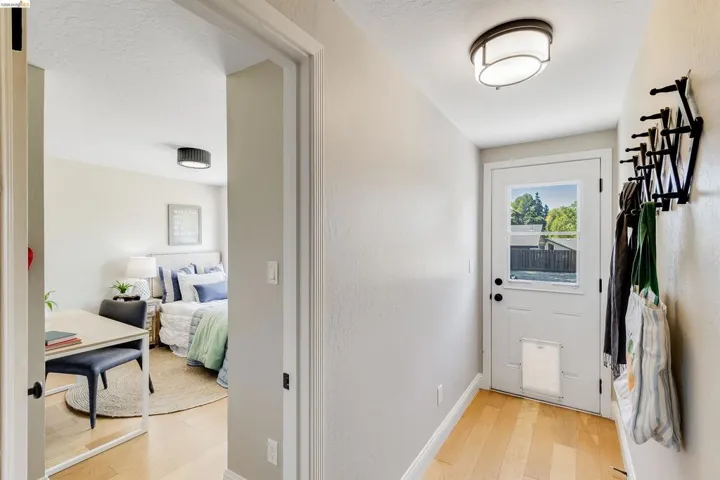 Entryway featuring light wood-finish flooring and a white paneled door with an integrated window