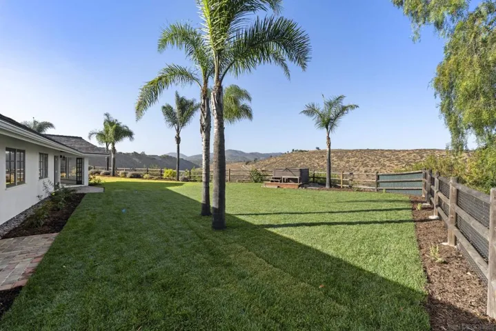 Fenced backyard with newly planted sod