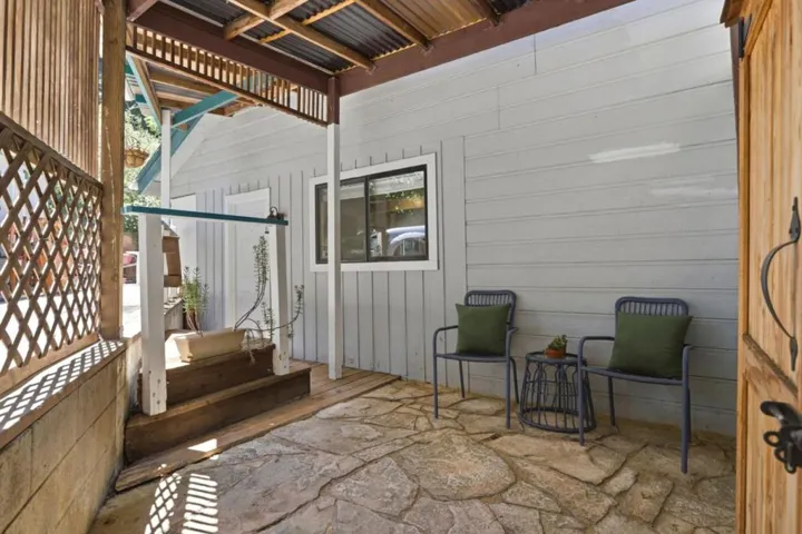 There is a covered patio just off the parking area and to the right of the kitchen door.