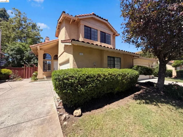 Mediterranean-style stucco exterior with a terra cotta tile roof