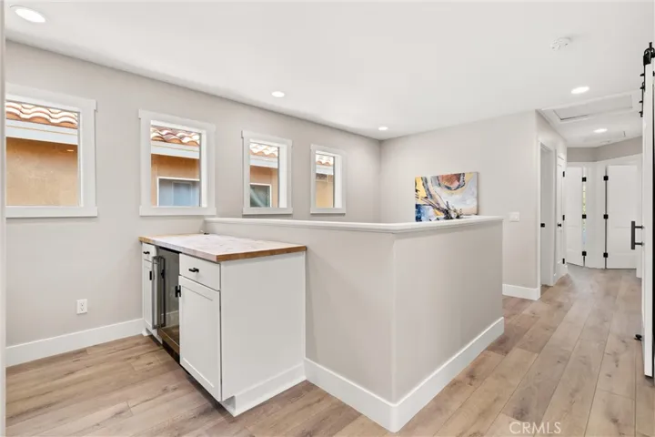 Versatile upstairs loft area with built-in beverage station and workspace