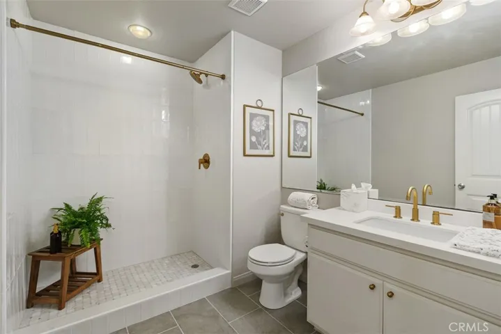 Updated main floor bathroom with walk-in shower and new quartz countertop