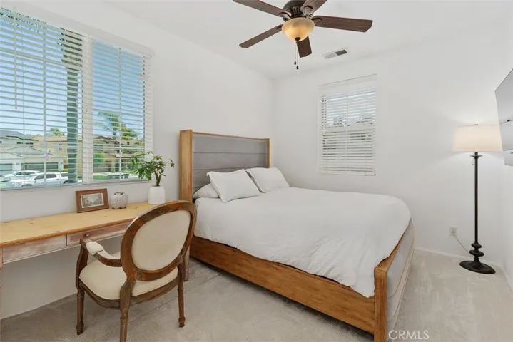 Bright main floor bedroom with mirrored closet doors