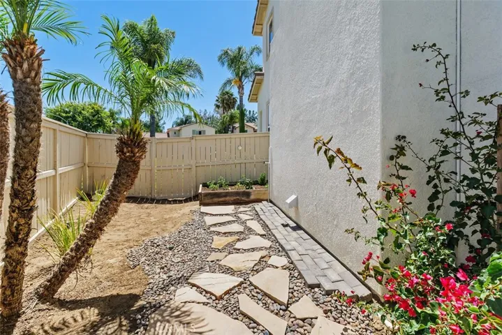 Side yard with raised garden bed
