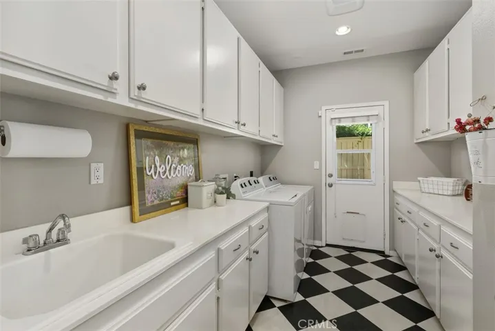 Individual Laundry room with tons of cabinets and counter space, Door to exterior