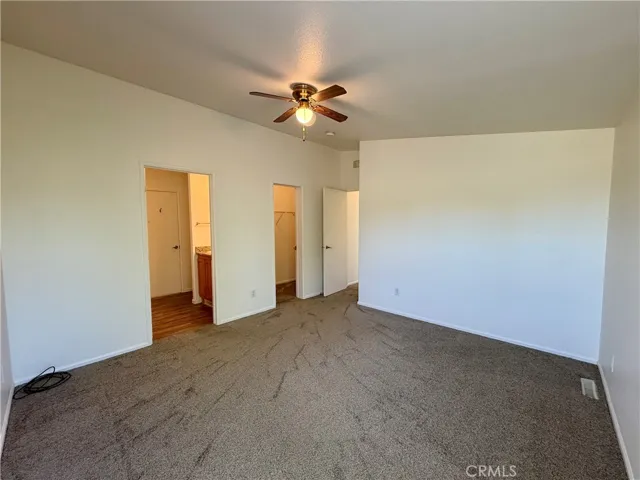 Primary bedroom looking into bathroom and closet