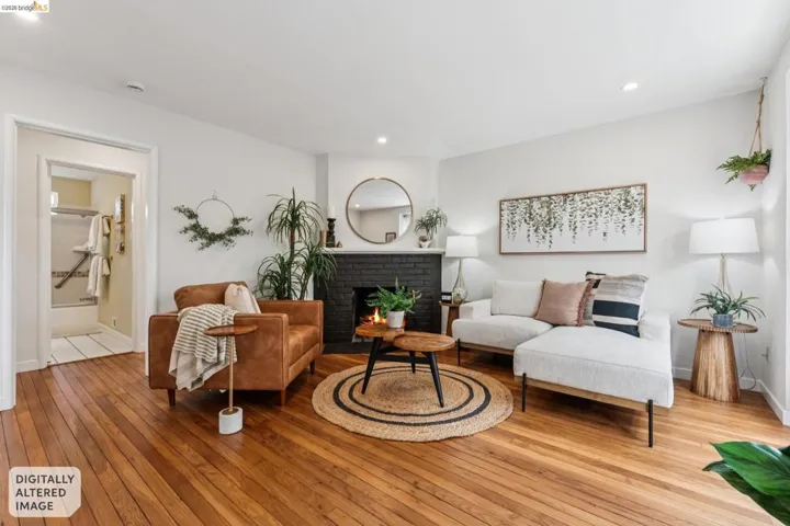 Living area featuring wood-finish flooring and a black brick fireplace