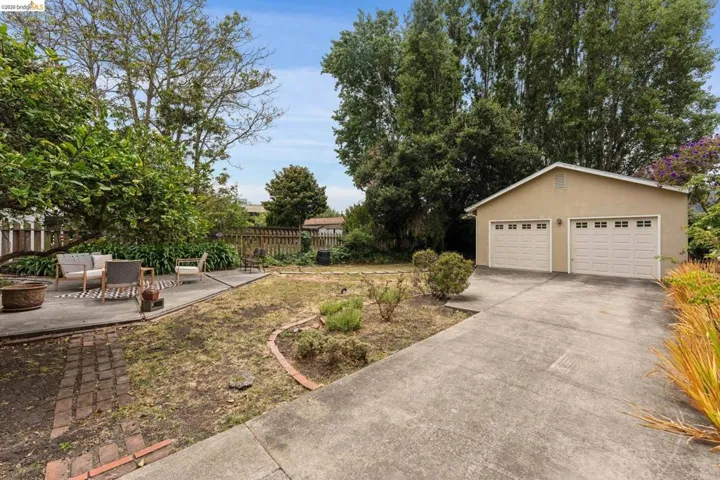Detached two-car garage with panel-style doors and upper window inserts