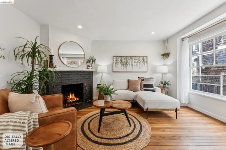 Living area featuring wood-finish flooring, a black brick fireplace with a white mantel, recessed lighting, and a large window