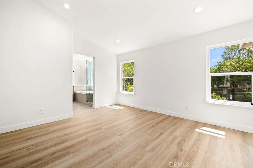 Spacious primary bedroom with direct access to the en-suite bathroom.