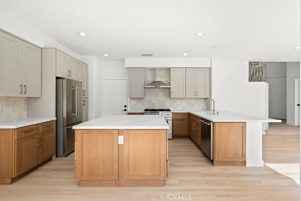 Reimagined designer kitchen featuring quartz countertops, a large center island, and abundant cabinetry.