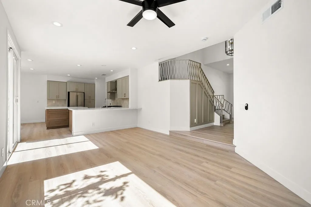 Open living area with luxury vinyl flooring and effortless flow between the kitchen and family room.