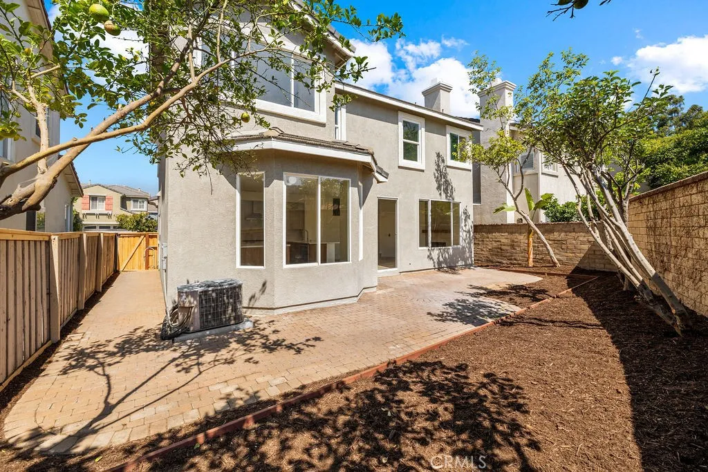 Private backyard featuring mature landscaping and an expansive patio area.