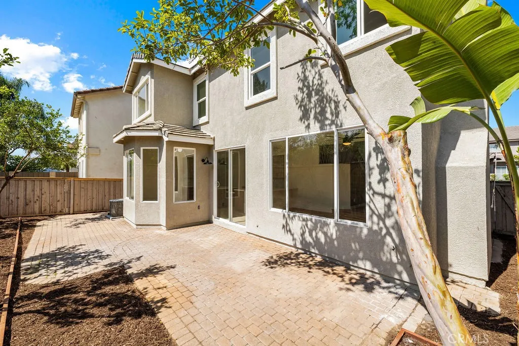 Low-maintenance backyard patio offers space for outdoor dining, entertaining, or relaxing.