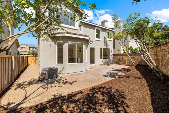 Private backyard featuring mature landscaping and an expansive patio area.