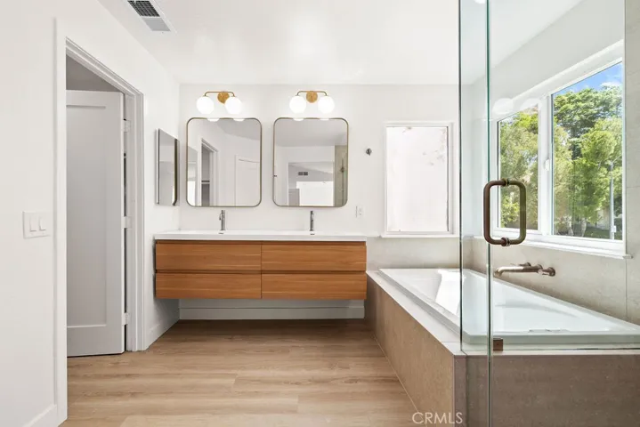 Elegant primary bath with designer finishes, dual sinks, and oversized vanity.