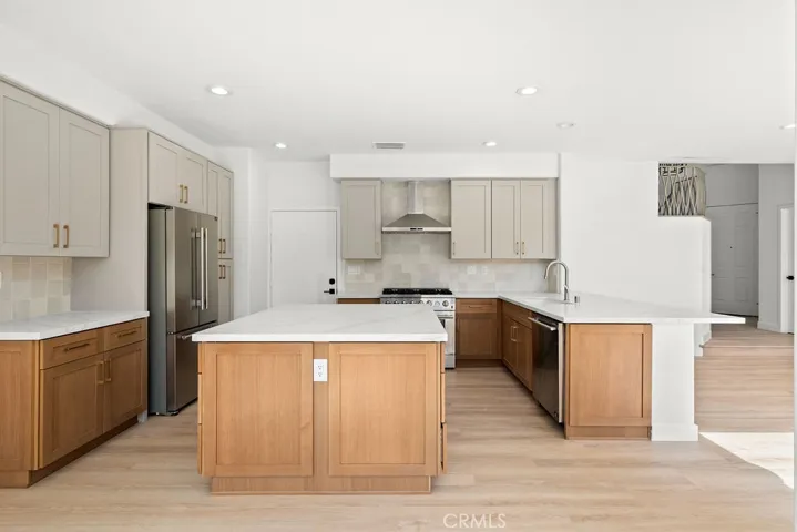Reimagined designer kitchen featuring quartz countertops, a large center island, and abundant cabinetry.