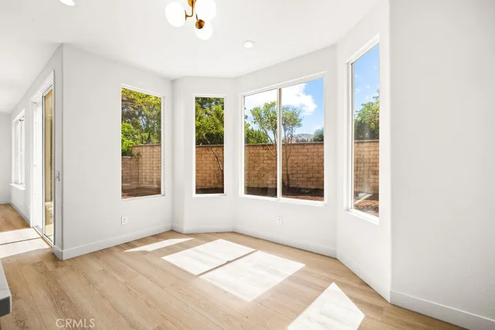 Dining area surrounded by windows, filling the space with abundant natural light.