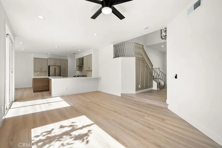 Open living area with luxury vinyl flooring and effortless flow between the kitchen and family room.