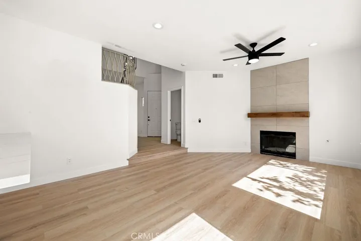 Family room featuring a contemporary fireplace, recessed lighting, and soaring ceilings.