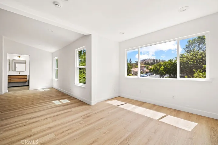 Expansive primary suite offering abundant natural light and a flexible retreat area.