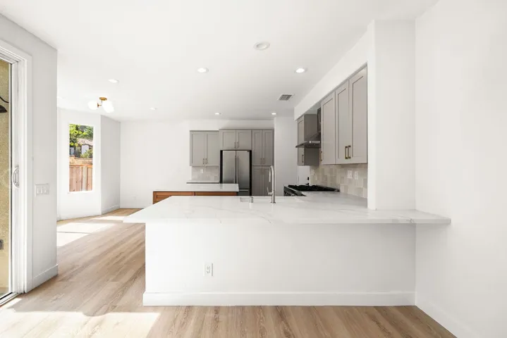 Large breakfast bar provides generous seating and additional workspace.