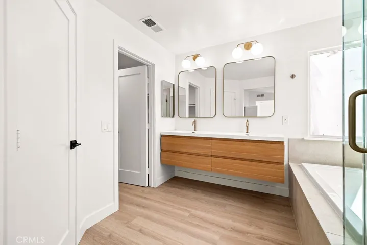 Spa-inspired primary bathroom offering a relaxing soaking tub and separate walk-in shower.