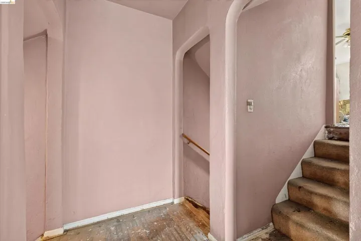 Interior entryway with textured walls and wood-finish flooring