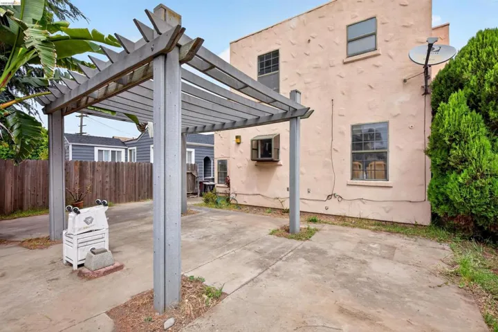 Concrete patio area featuring a wooden pergola structure
