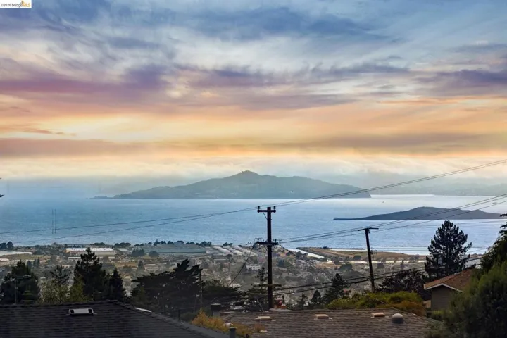 Expansive water vista featuring distant islands and a city skyline